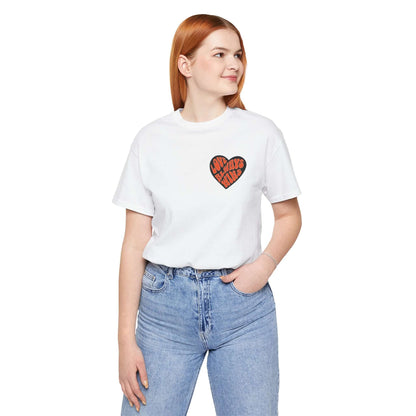 Unisex yoga love tee in white with heart design worn by model, perfect for yoga practice and mindfulness.